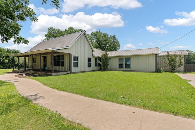 11240 County Road 102, Grandview, TX 76050 - view of front of home with board and batten siding, metal roof, a front lawn, and covered porch