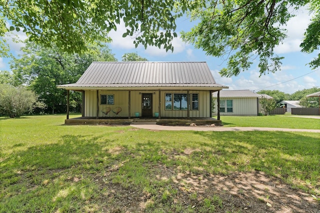 11240 County Road 102, Grandview, TX 76050 - view of front of home with board and batten siding, covered porch, and a front lawn