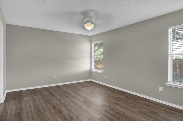 2532 Nogales Dr, Fort Worth, TX 76108 - unfurnished room featuring dark wood-type flooring, plenty of natural light, baseboards, and a textured ceiling