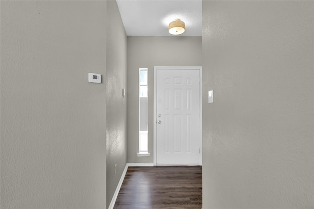 2532 Nogales Dr, Fort Worth, TX 76108 - foyer entrance featuring dark wood-style flooring, baseboards, and a textured wall