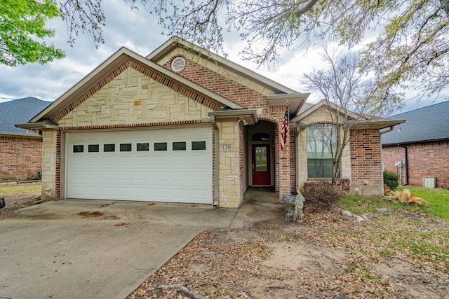120 Saint Francis Ln, Mabank, TX 75156 - view of front of home featuring driveway, stone siding, and an attached garage