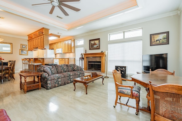 120 Saint Francis Ln, Mabank, TX 75156 - living room featuring crown molding, ceiling fan, plenty of natural light, a raised ceiling, and a glass covered fireplace