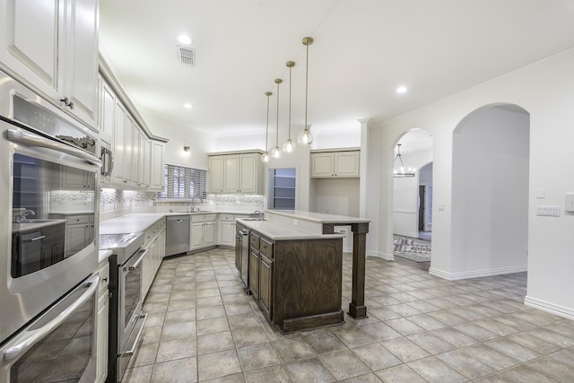 124 Fm 2450, Krum, TX 76249 - kitchen featuring stainless steel appliances, backsplash, arched walkways, a kitchen breakfast bar, and a kitchen island