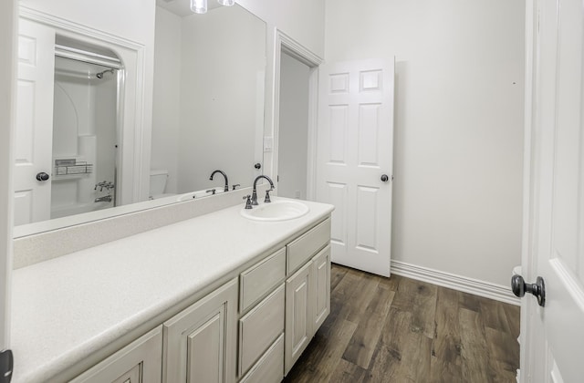124 Fm 2450, Krum, TX 76249 - bathroom with vanity, wood finished floors, baseboards, toilet, and shower / tub combination