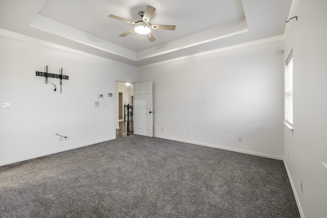 124 Fm 2450, Krum, TX 76249 - spare room with a tray ceiling, ceiling fan, dark colored carpet, and baseboards