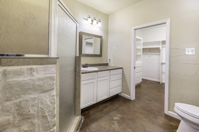 124 Fm 2450, Krum, TX 76249 - full bathroom featuring concrete floors, vanity, toilet, and a spacious closet