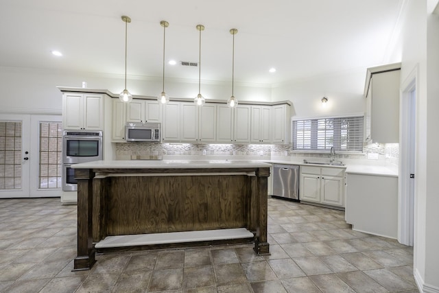 124 Fm 2450, Krum, TX 76249 - kitchen with stainless steel appliances, backsplash, a sink, light countertops, and a kitchen island