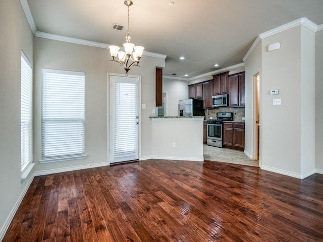 8808 Papa Trl, Mckinney, TX 75070 - kitchen with appliances with stainless steel finishes, a chandelier, dark brown cabinets, wood finished floors, and ornamental molding