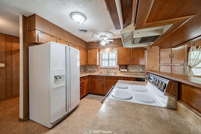 2302 13th, Brownwood, TX 76801 - kitchen featuring white appliances, brown cabinets, a ceiling fan, a textured ceiling, and light countertops