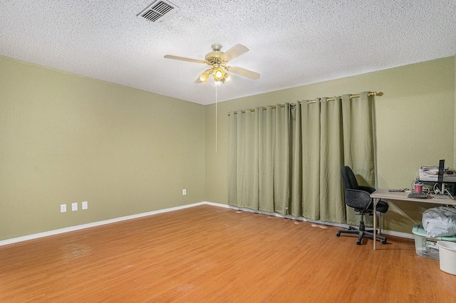 6204 Pennsylvania Ave, Arlington, TX 76017 - office area with wood finished floors, a ceiling fan, and a textured ceiling