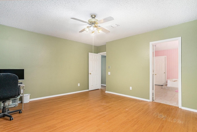 6204 Pennsylvania Ave, Arlington, TX 76017 - office featuring light wood-type flooring, a ceiling fan, and a textured ceiling