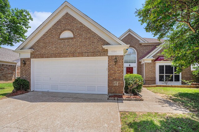 6204 Pennsylvania Ave, Arlington, TX 76017 - view of front of property with brick siding, driveway, and a garage