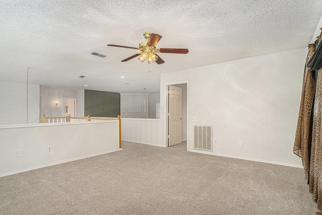 6204 Pennsylvania Ave, Arlington, TX 76017 - unfurnished living room featuring carpet floors, a ceiling fan, and a textured ceiling