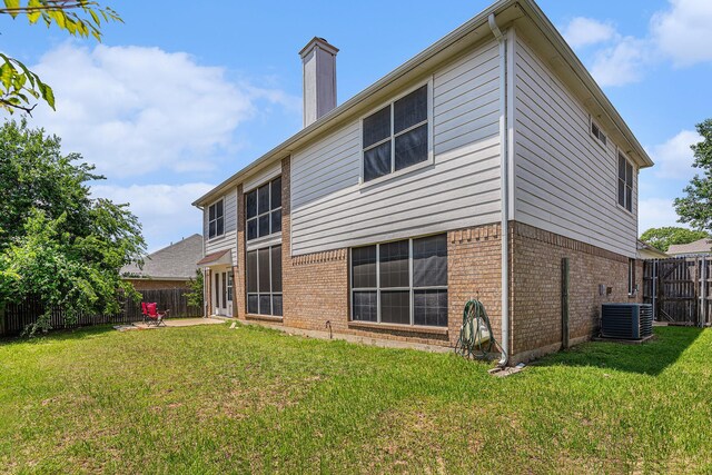 6204 Pennsylvania Ave, Arlington, TX 76017 - back of house featuring brick siding, a patio, a fenced backyard, and a chimney