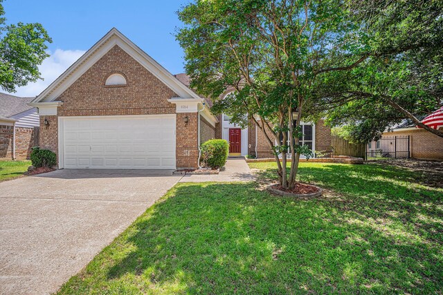6204 Pennsylvania Ave, Arlington, TX 76017 - view of front facade with brick siding, concrete driveway, and a garage
