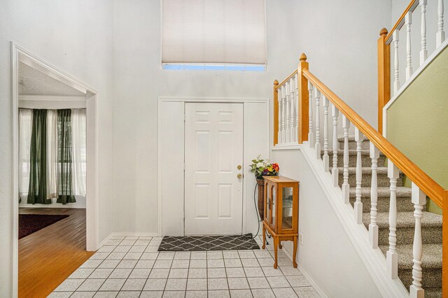 6204 Pennsylvania Ave, Arlington, TX 76017 - foyer entrance featuring a towering ceiling, light tile patterned floors, and stairway