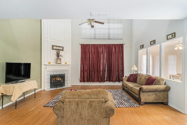 6204 Pennsylvania Ave, Arlington, TX 76017 - living room featuring a ceiling fan, a towering ceiling, light wood-style floors, and a fireplace
