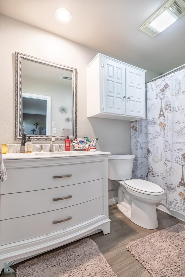1626 Morrow Ln, Abilene, TX 79601 - full bathroom with toilet, vanity, wood finished floors, and curtained shower