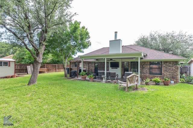 1626 Morrow Ln, Abilene, TX 79601 - back of house with a ceiling fan, a patio area, brick siding, and a chimney