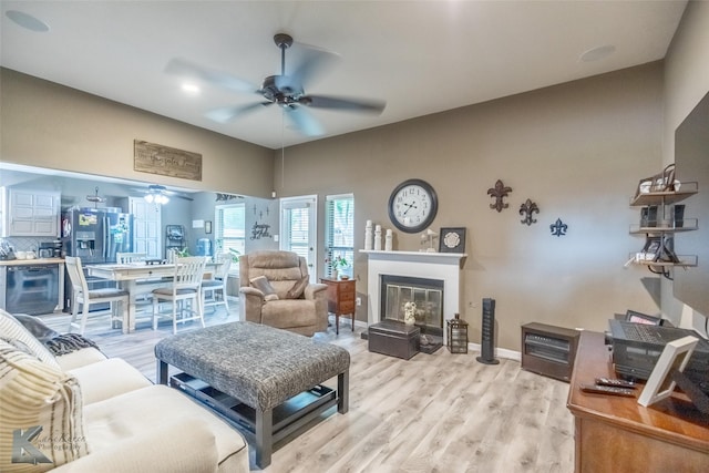 1626 Morrow Ln, Abilene, TX 79601 - living area featuring a ceiling fan, light wood finished floors, a glass covered fireplace, baseboards, and beverage cooler