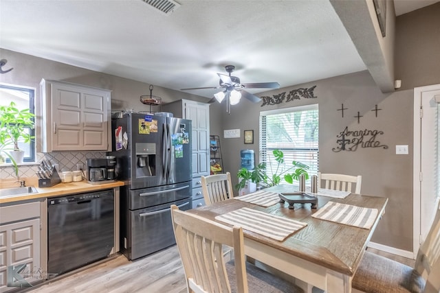 1626 Morrow Ln, Abilene, TX 79601 - kitchen with black dishwasher, stainless steel fridge with ice dispenser, light wood-type flooring, tasteful backsplash, and ceiling fan