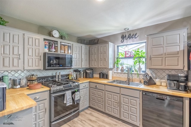 1626 Morrow Ln, Abilene, TX 79601 - kitchen featuring appliances with stainless steel finishes, wooden counters, and a sink