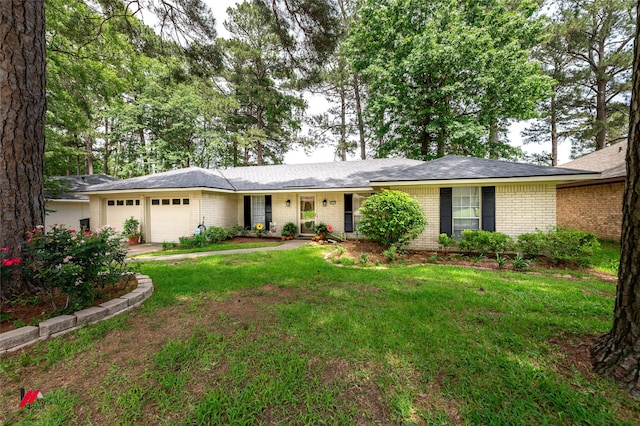 9507 Chapparral Ln, Shreveport, LA 71118 - ranch-style house featuring brick siding, a garage, a front lawn, and concrete driveway