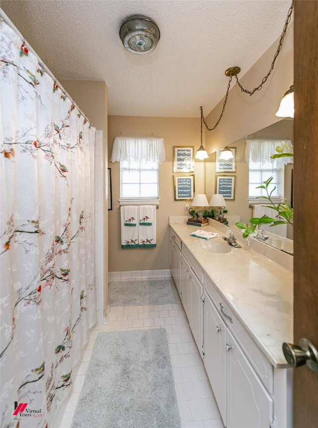 9507 Chapparral Ln, Shreveport, LA 71118 - full bathroom featuring a textured ceiling, tile patterned flooring, vanity, and a shower with shower curtain
