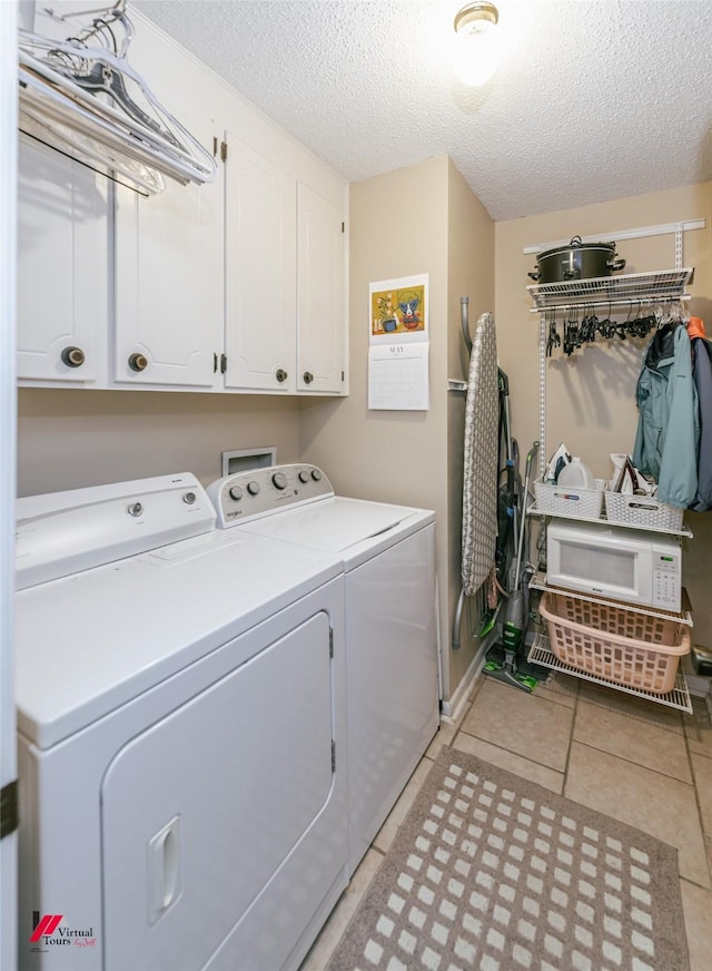 9507 Chapparral Ln, Shreveport, LA 71118 - laundry area with cabinet space, washer and dryer, a textured ceiling, and light tile patterned floors