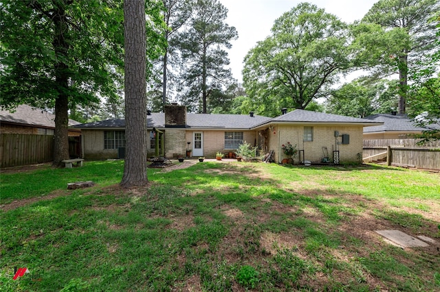 9507 Chapparral Ln, Shreveport, LA 71118 - rear view of property featuring brick siding and a chimney