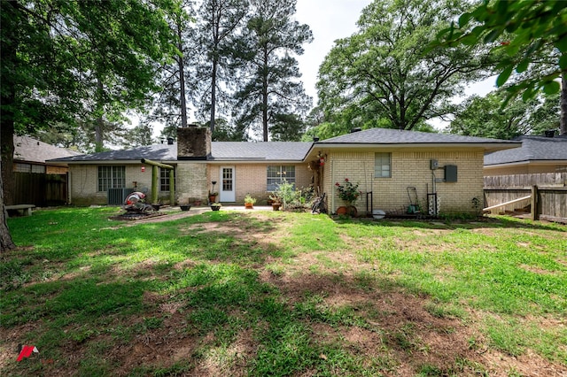 9507 Chapparral Ln, Shreveport, LA 71118 - back of house featuring brick siding, a chimney, a patio area, and central AC unit