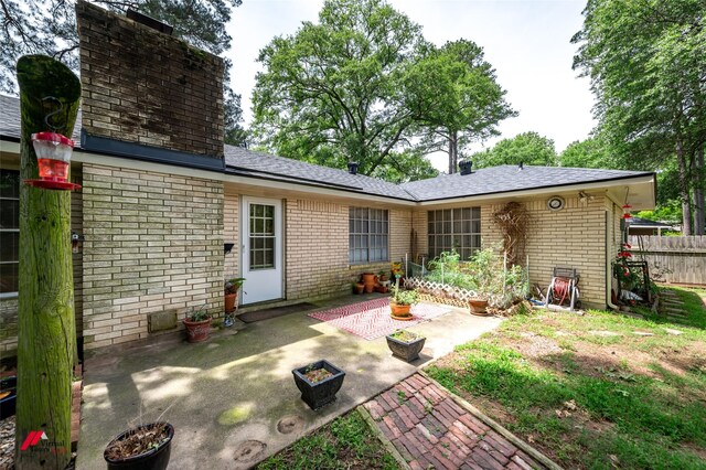 9507 Chapparral Ln, Shreveport, LA 71118 - rear view of house with a patio, brick siding, and fence