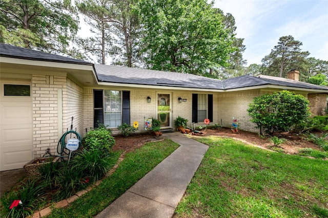 9507 Chapparral Ln, Shreveport, LA 71118 - view of front of home with brick siding, an attached garage, and a chimney