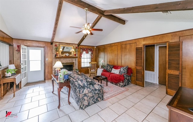9507 Chapparral Ln, Shreveport, LA 71118 - living area featuring wood walls, a ceiling fan, light tile patterned floors, and a fireplace