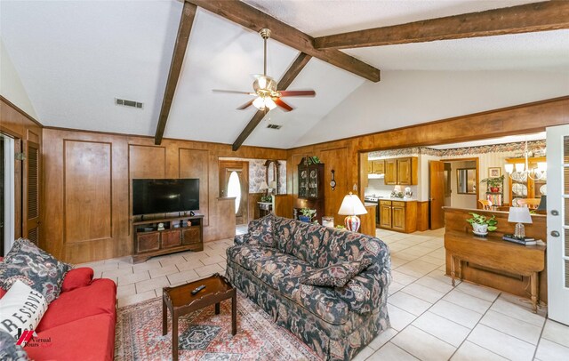9507 Chapparral Ln, Shreveport, LA 71118 - living room featuring wood walls, light tile patterned floors, ceiling fan, and a chandelier