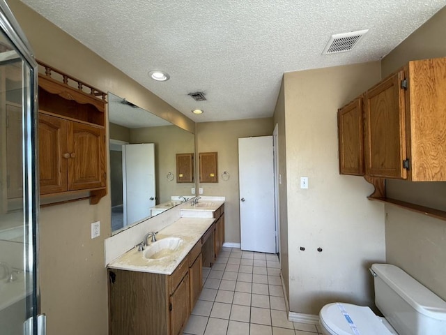 1420 Alta Mesa Ct, Mesquite, TX 75150 - full bath featuring a textured ceiling, toilet, tile patterned flooring, double vanity, and baseboards