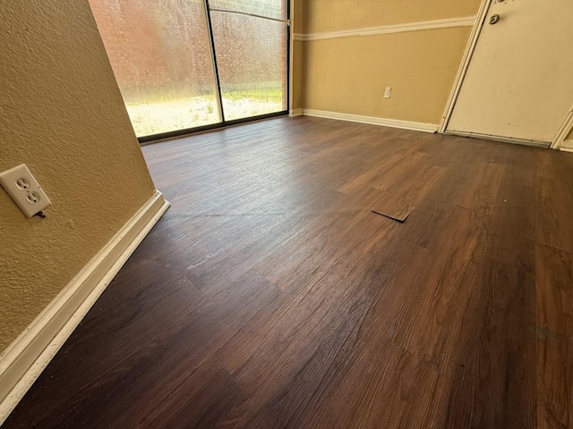 1420 Alta Mesa Ct, Mesquite, TX 75150 - unfurnished room with dark wood-type flooring, a textured wall, and baseboards
