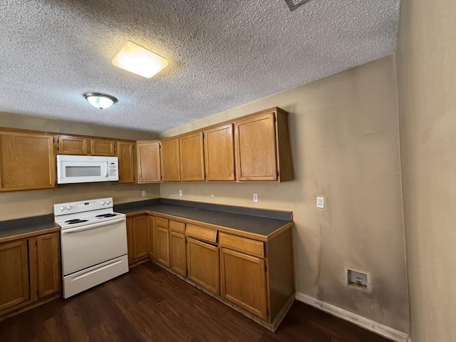 1420 Alta Mesa Ct, Mesquite, TX 75150 - kitchen with white appliances, dark countertops, dark wood-type flooring, a textured ceiling, and brown cabinetry