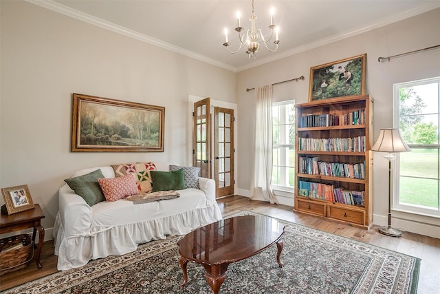 182 Hcr 1431, Covington, TX 76636 - living area with wood finished floors, a chandelier, plenty of natural light, and ornamental molding