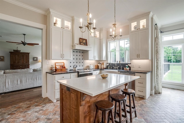 182 Hcr 1431, Covington, TX 76636 - kitchen featuring brick floors, ornamental molding, stainless steel appliances, open floor plan, and a chandelier