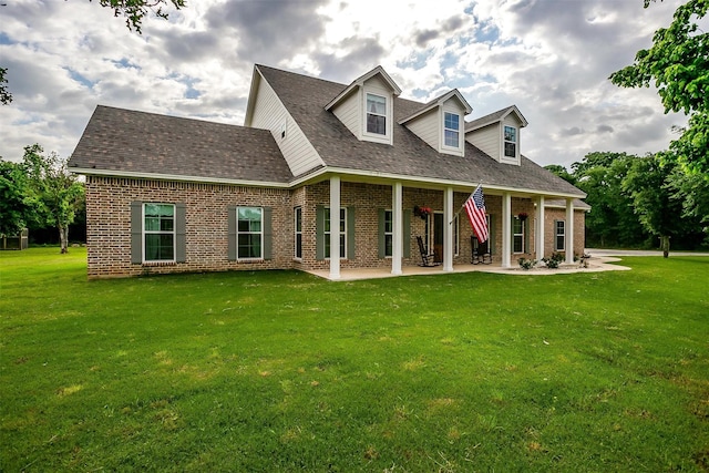 182 Hcr 1431, Covington, TX 76636 - new england style home with brick siding, a front yard, a patio, and roof with shingles