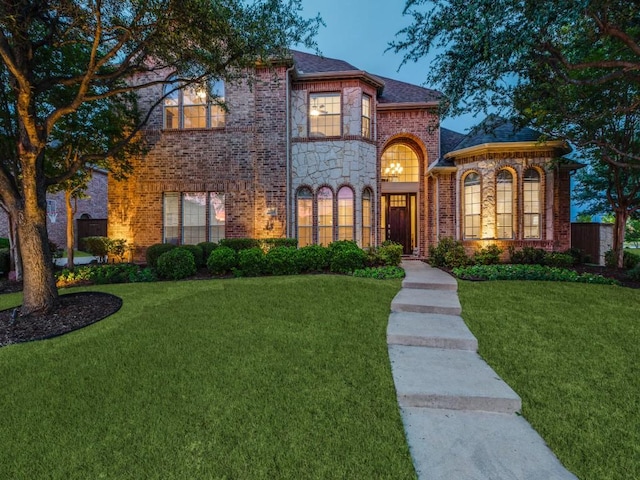 5924 Deerwood Ln, Frisco, TX 75036 - view of front of home with brick siding, a yard, and stone siding