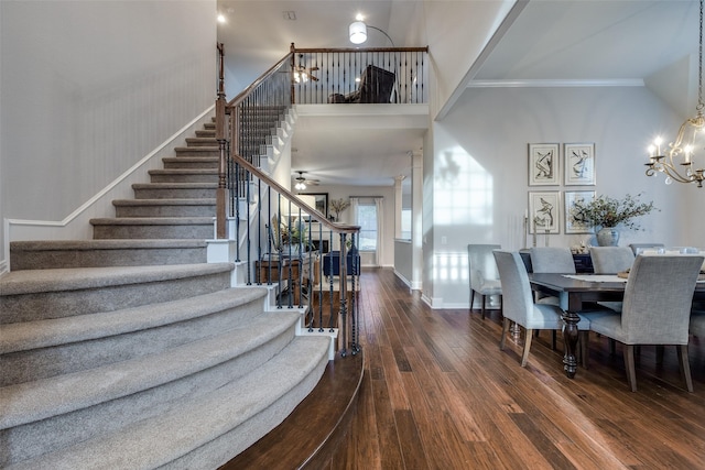 5924 Deerwood Ln, Frisco, TX 75036 - staircase with hardwood / wood-style flooring, a chandelier, ornamental molding, a high ceiling, and baseboards