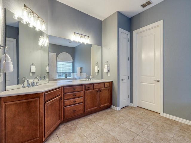 5924 Deerwood Ln, Frisco, TX 75036 - bathroom featuring double vanity, tile patterned floors, and baseboards