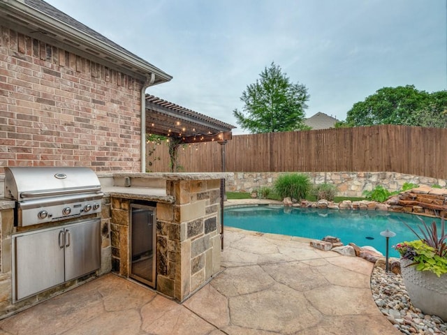 5924 Deerwood Ln, Frisco, TX 75036 - view of pool with exterior kitchen, a fenced backyard, grilling area, a patio area, and a pergola