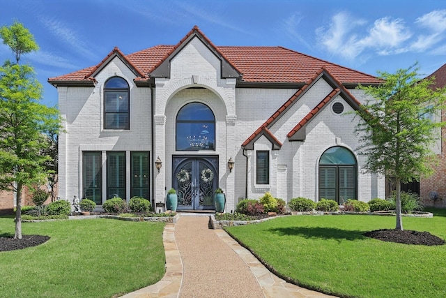 3921 Overlake Dr, Plano, TX 75023 - french country home featuring french doors, a tile roof, and a front yard