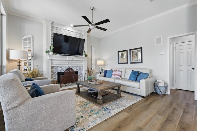 3921 Overlake Dr, Plano, TX 75023 - living area featuring ornamental molding, wood finished floors, ceiling fan, and a fireplace