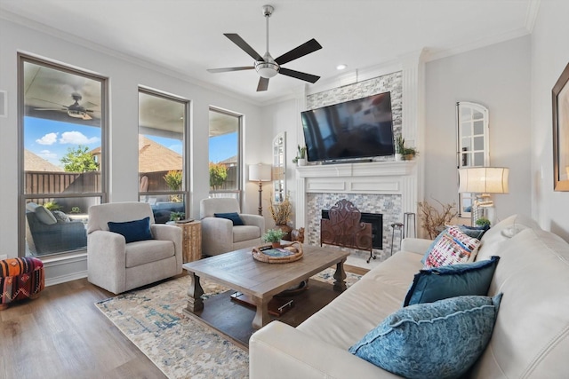 3921 Overlake Dr, Plano, TX 75023 - living area with a ceiling fan, crown molding, wood finished floors, a large fireplace, and recessed lighting