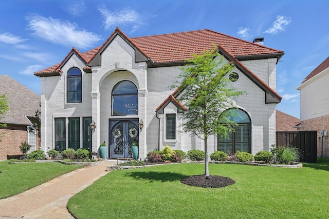 3921 Overlake Dr, Plano, TX 75023 - french provincial home featuring french doors, a tiled roof, and brick siding