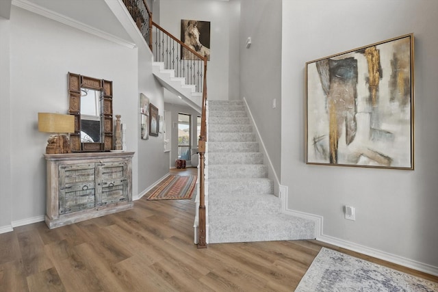 3921 Overlake Dr, Plano, TX 75023 - staircase with baseboards, wood finished floors, and a towering ceiling